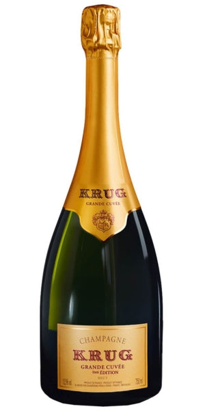Bottle of Krug Grande Cuvee champagne with gold foil cap on a white background