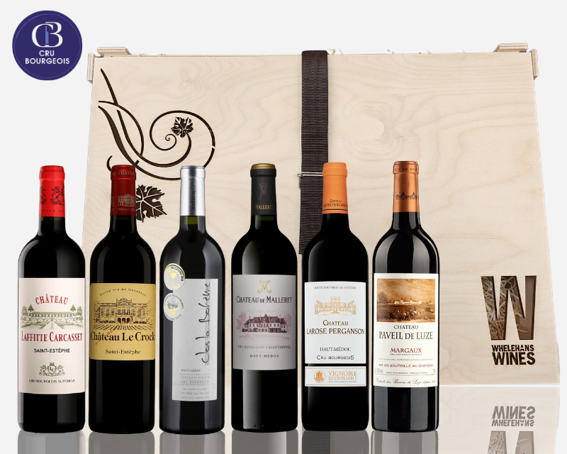 Collection of Cru Bourgeois wine bottles in front of a branded wooden box