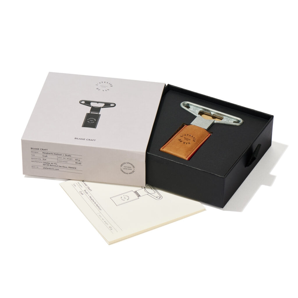 Bottle opener with leather patch in a black box on a white background