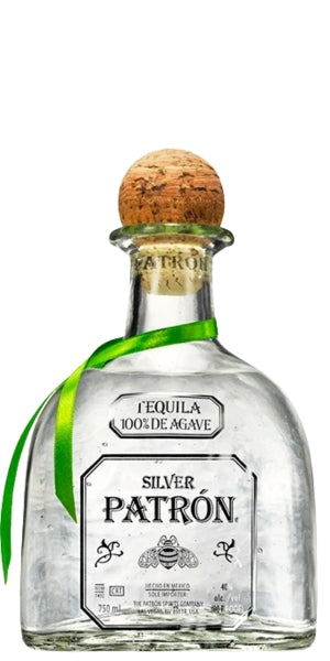 A bottle of Silver Patron tequila with a cork stopper and a green ribbon, shown on a plain white background. By whelehans Wines. 
